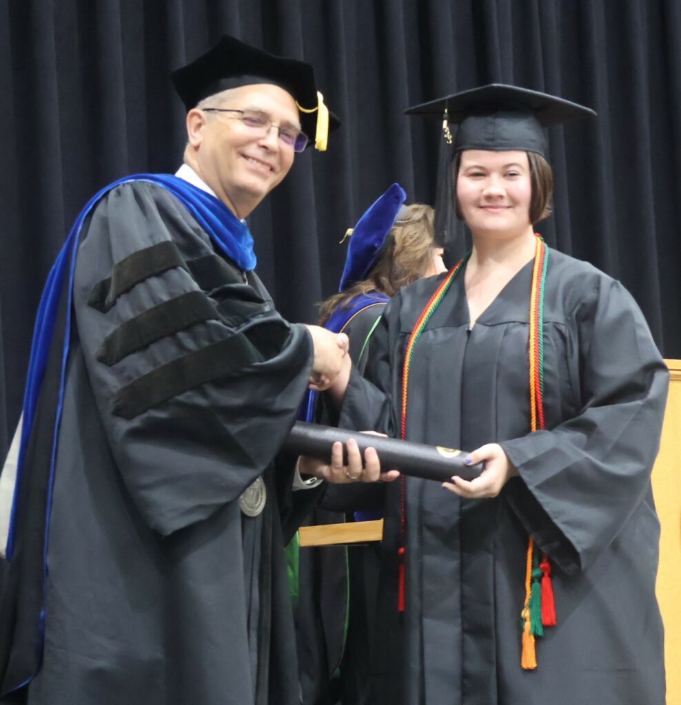 Dr. Hummel, left, congratulates Breanna Mathes.