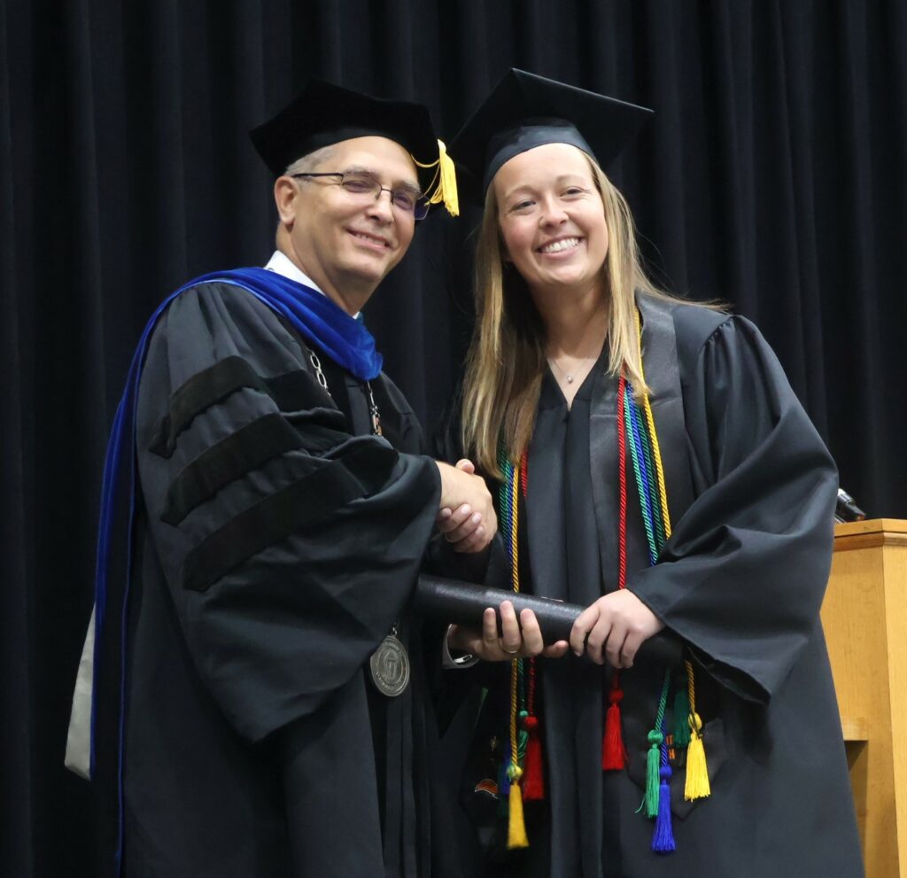 Dr. Hummel, left, congratulates Keylon Reynolds.
