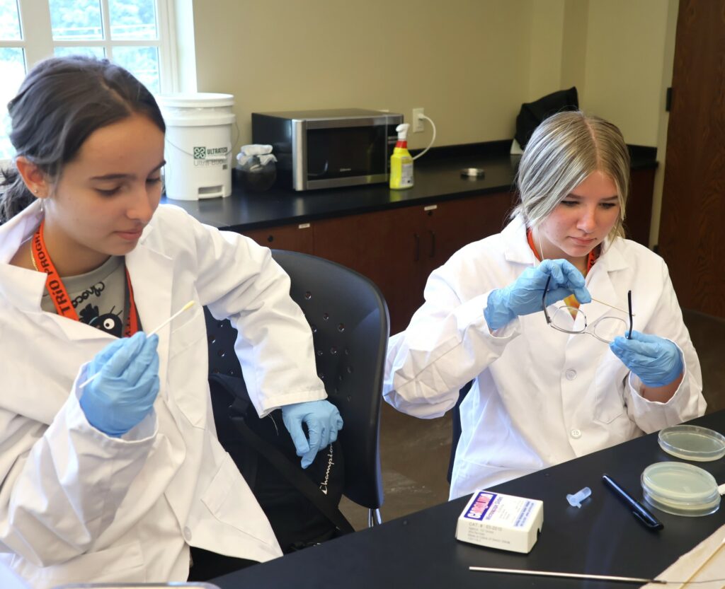 Two students work on a project in their microbiology class.