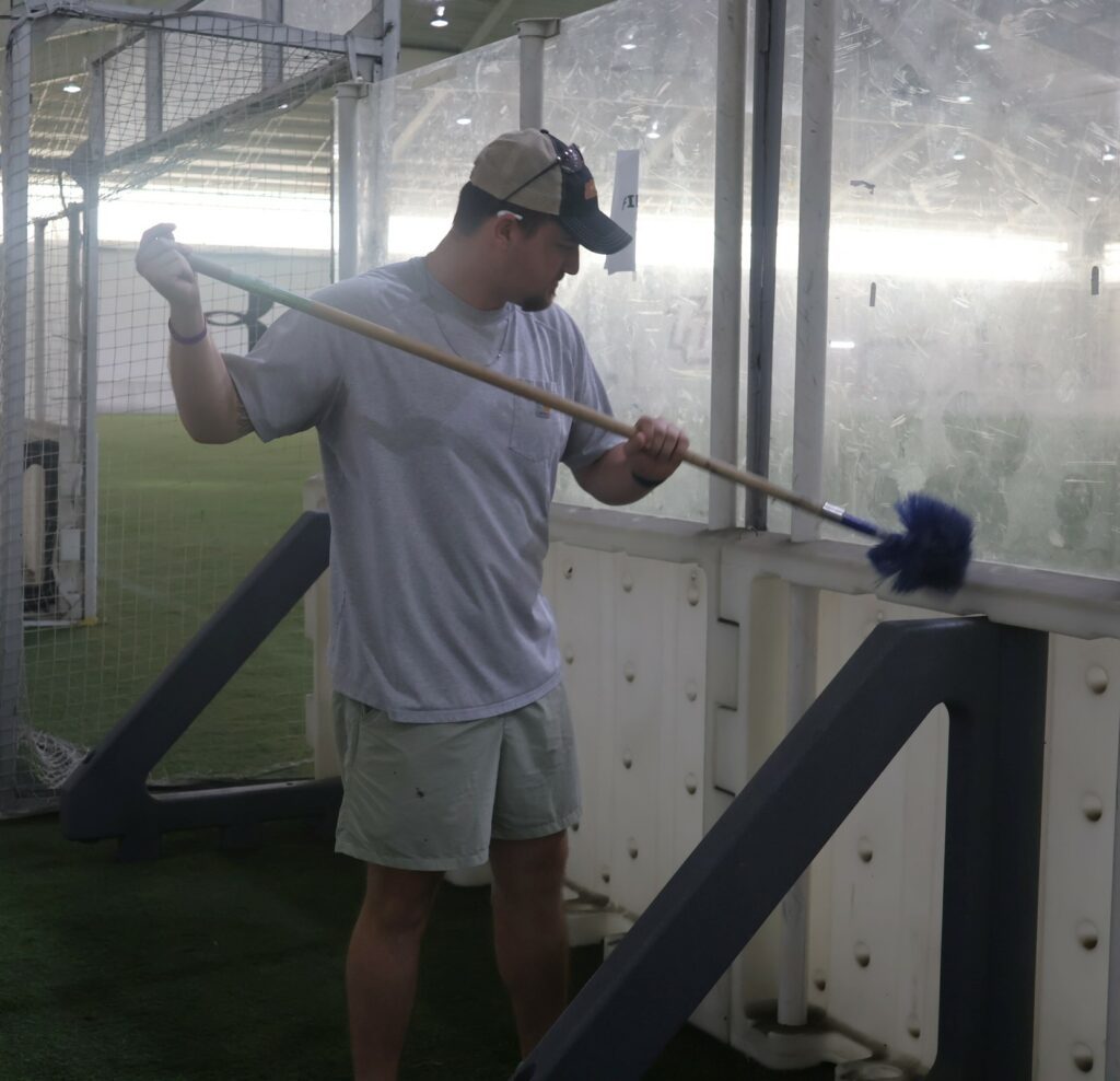 An employee cleans at the Indoor Practice Facility.