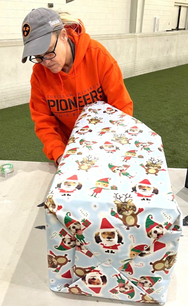 Jennifer Wilhoit wraps a gift.