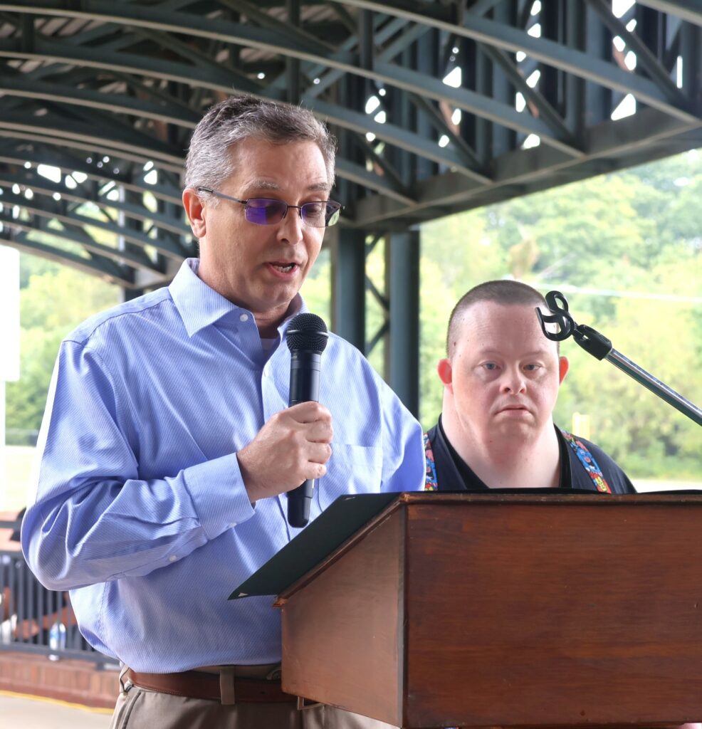 Dr. Hummel, left, reads a state resolution for Travis Parton.