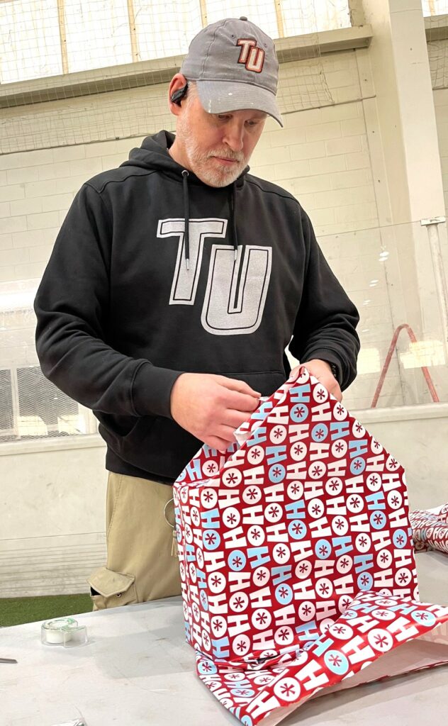 Max Olmsted wraps a gift.
