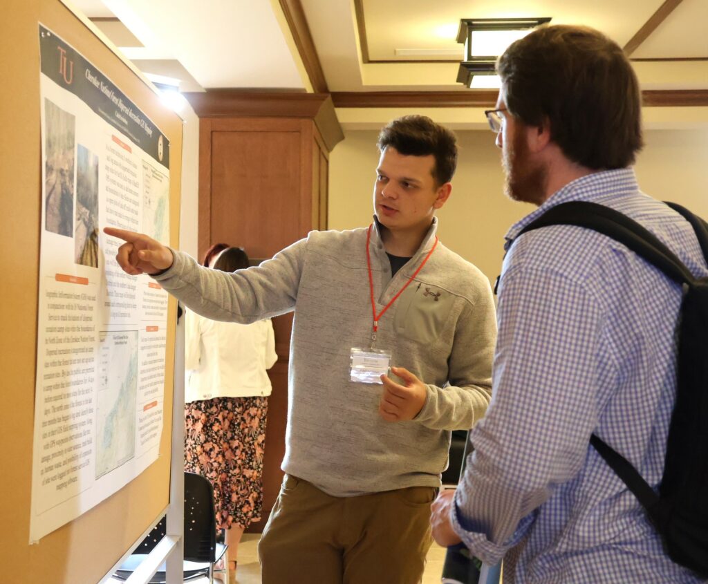 Caleb Swinehart discusses his poster.