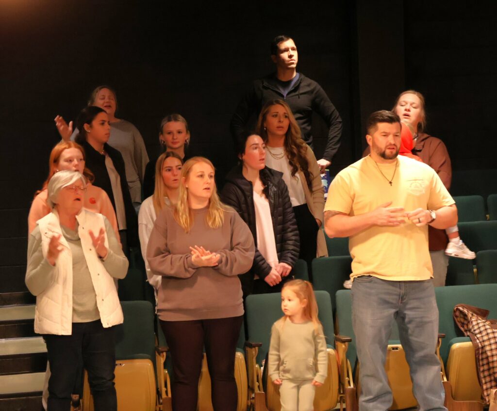 Community members sing.