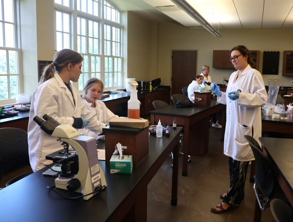 Shannon Elliott, right, who taught the Introduction to Microbiology class, speaks with some of her students.