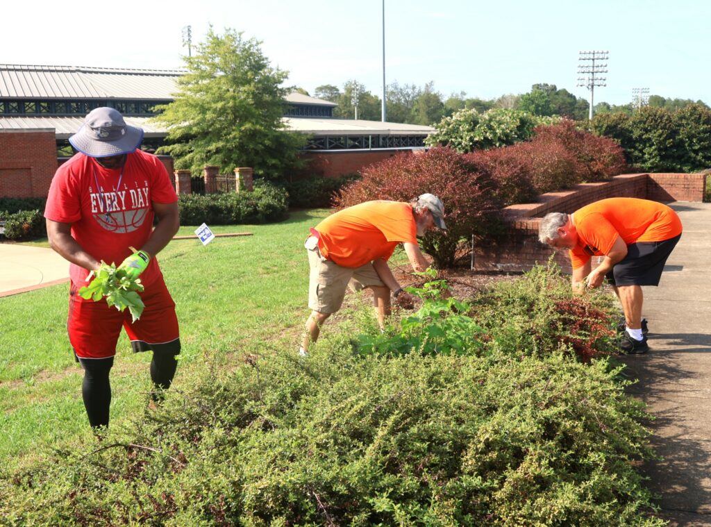 Left to right, Steve Anderson, Todd Hertel and Billy Taylor remove undesired items.