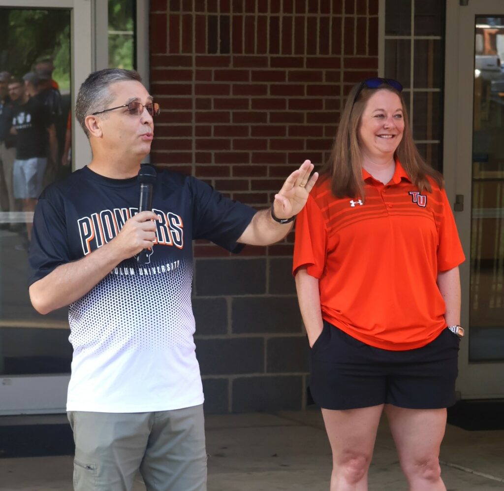 Dr. Hummel, left, speaks while Carrie Maggert listens.