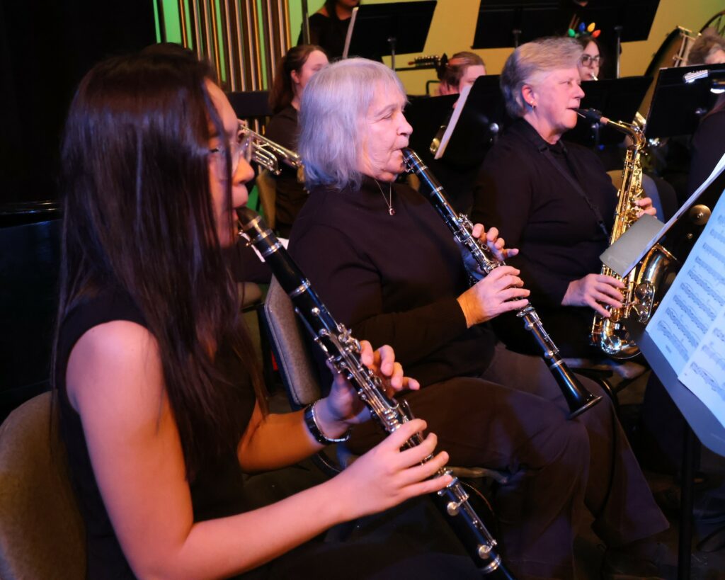 Three band members play before the concert starts.