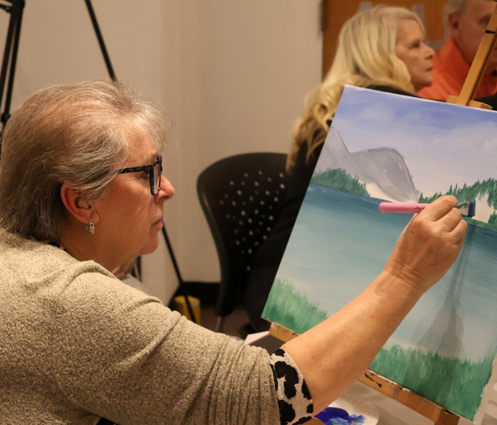 An attendee paints.