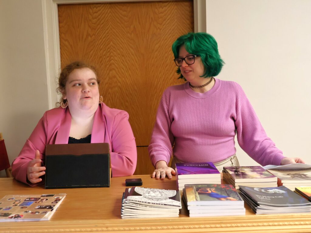 Students Zoey Seay, left, and Kiersten Paxton help greet guests arriving at the lecture.