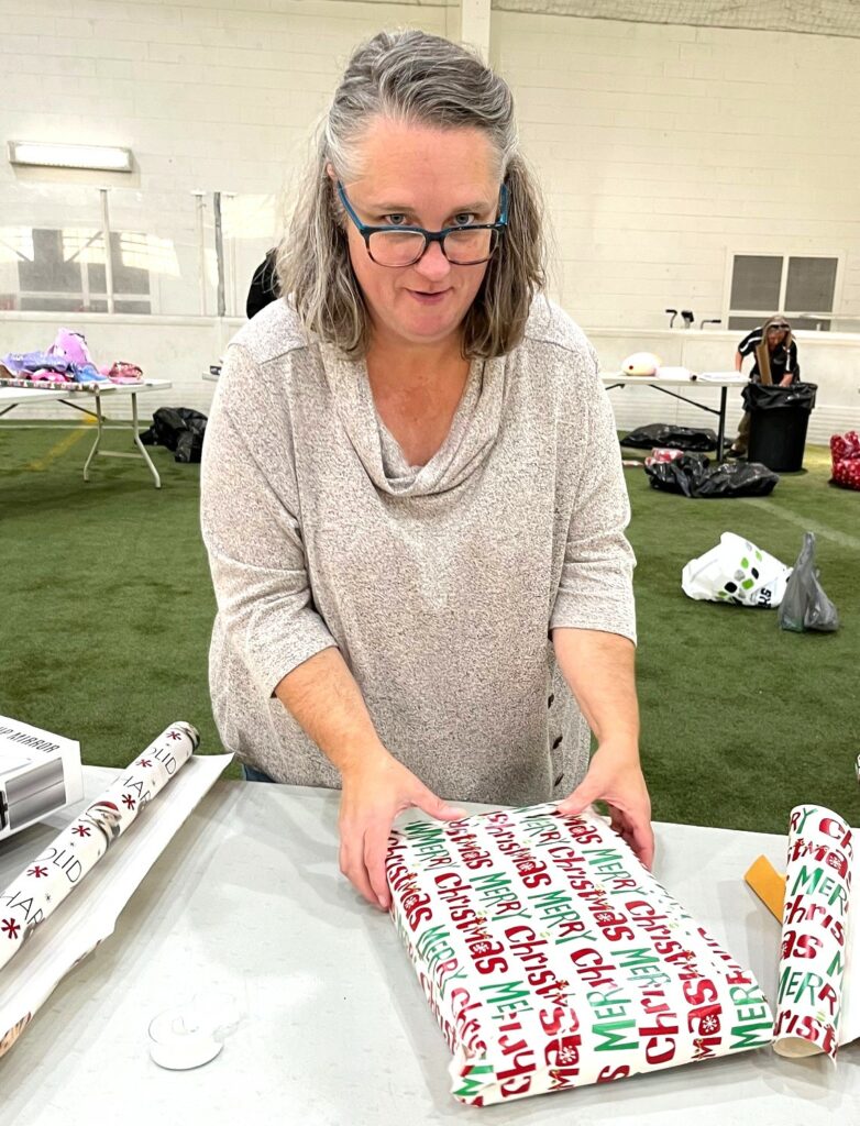 Jenni Bowman wraps a gift.