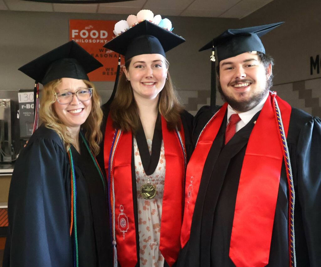 Left to right, Sydney May, Samantha Nelson and Hughston Burnheimer celebrate before graduation.
