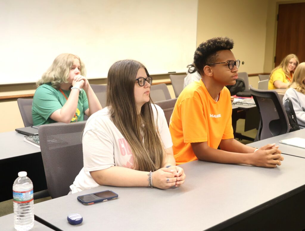 Students listen to Kassidy Babler teach her witch hunting class.