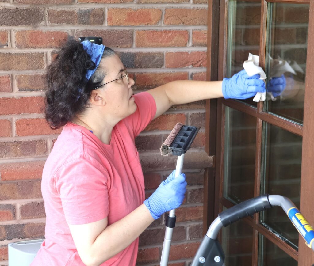 Dr. Aja Matthews wipes a window.