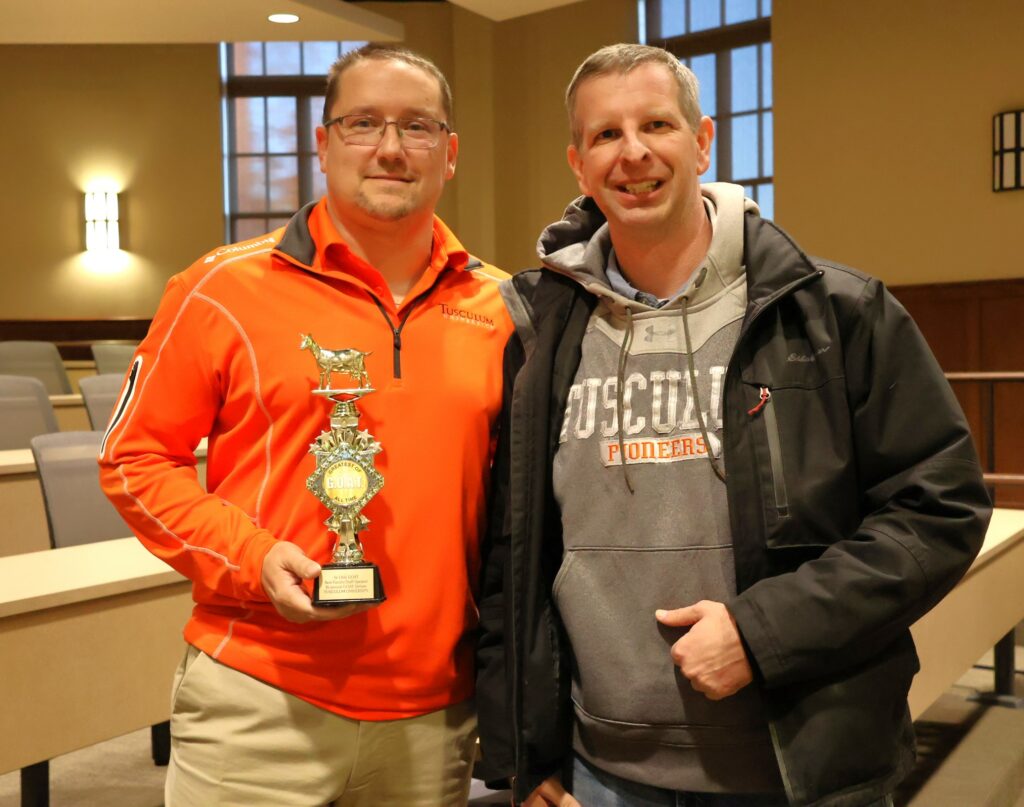 Mike Brisbin, left, accepts the Ye Olde GOAT trophy as the best faculty and staff speaker.