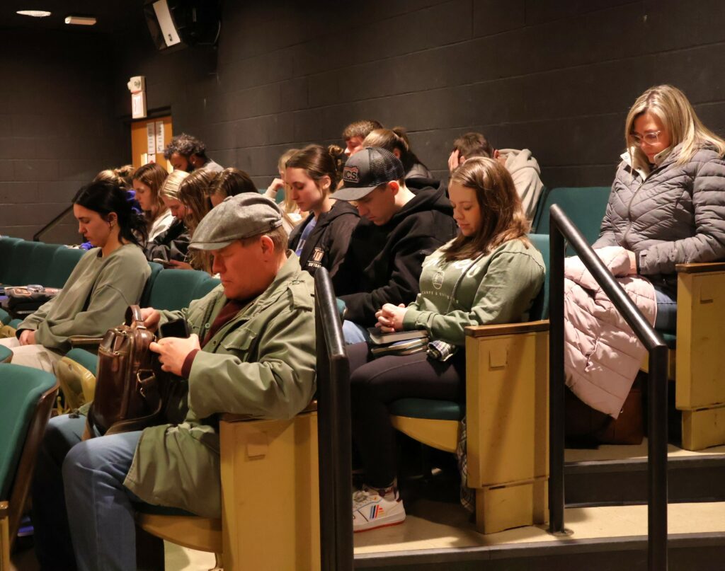 Students and community members pray.