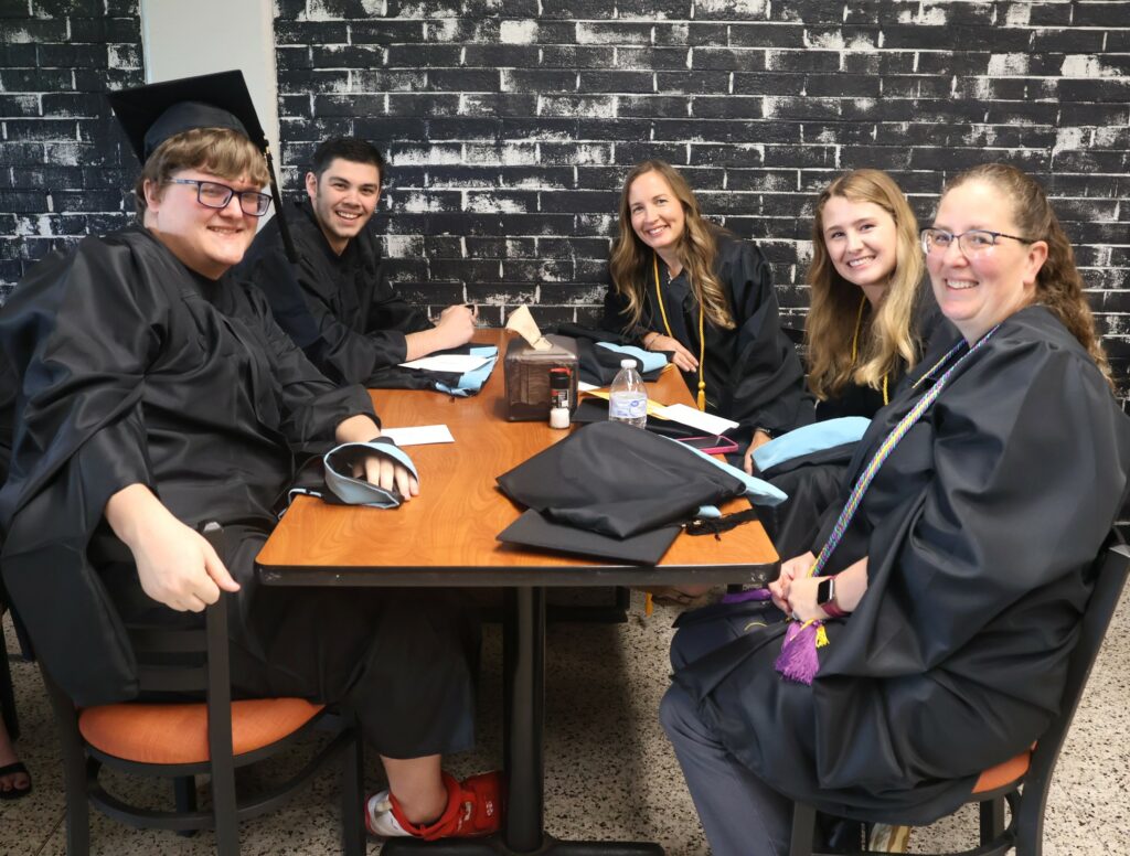 Graduates relax before the ceremony.