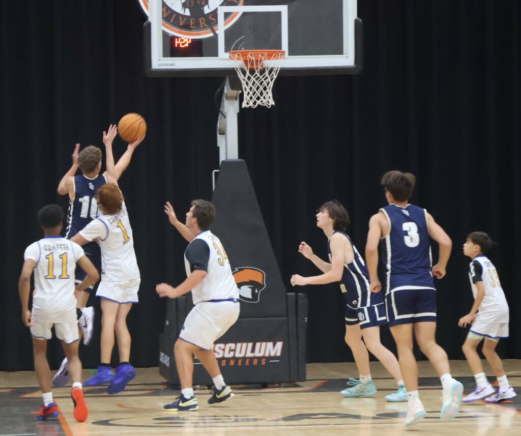 A player takes the ball to the hoop.