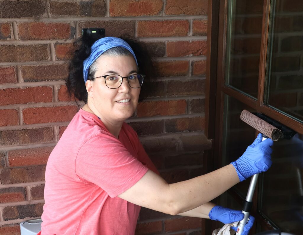 Dr. Aja Matthew prepares to clean a window.
