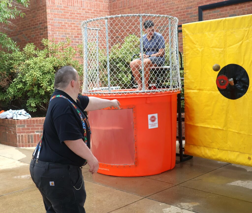 Travis Parton, left, seeks to dunk Dr. Suzanne Byrd.