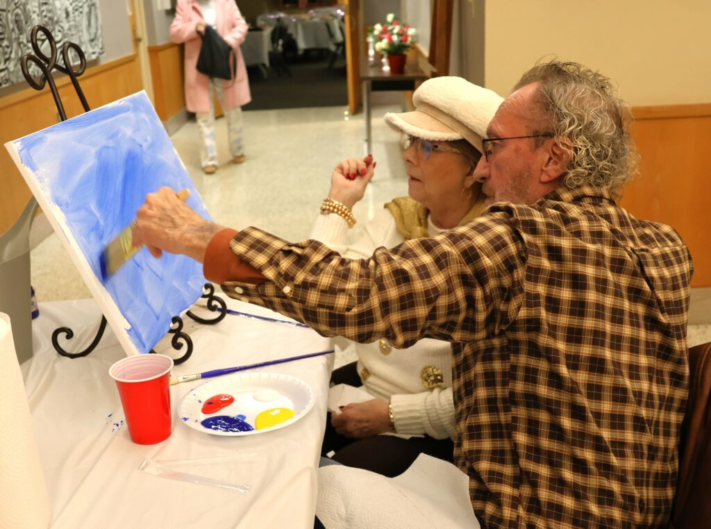 Attendees paint.