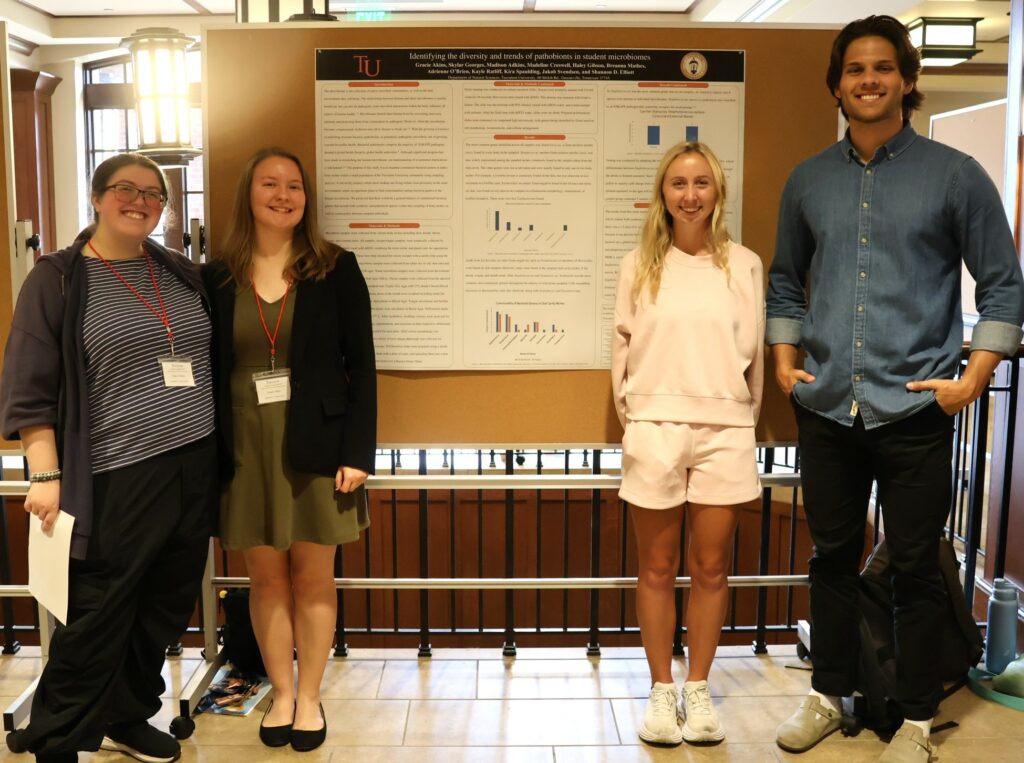 Left to right, Haley Gibson, Gracie Akins, Adrienne O'Brien and Jakob Svendsen stand by their poster.