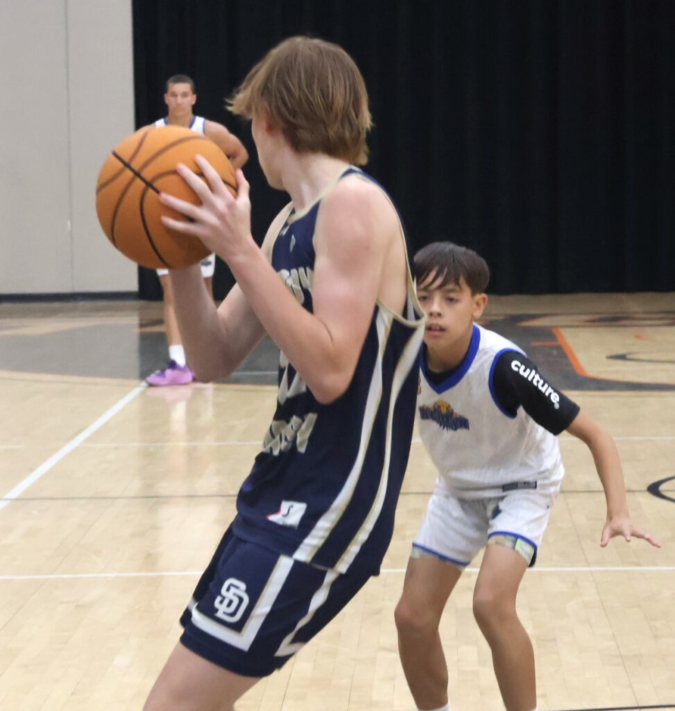 A player tries to advance the ball against the defender.