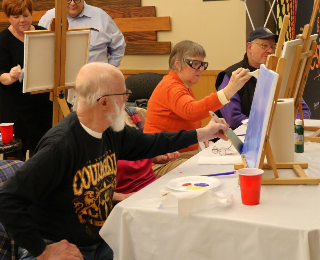 Attendees paint.