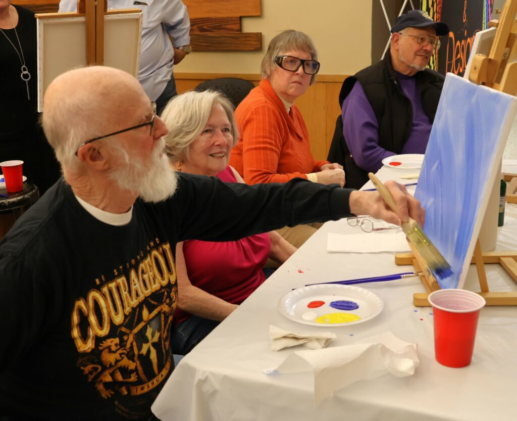 Attendees paint.