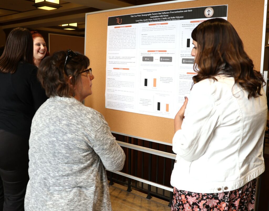 Lynzi Pitts, right, discusses her poster with Dr. Susan Monteleone.