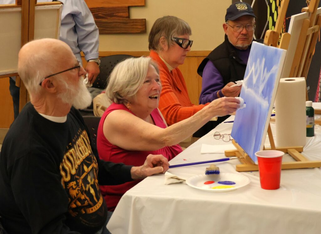 Attendees paint.