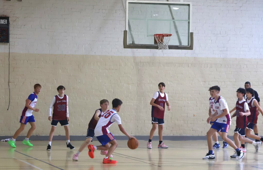 A player dribbles during the J.T. Burton Team Camp.