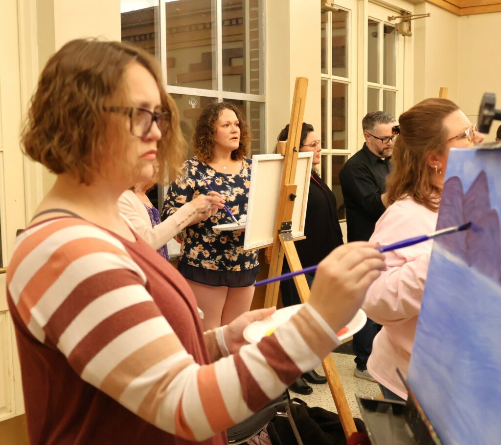 Attendees paint.