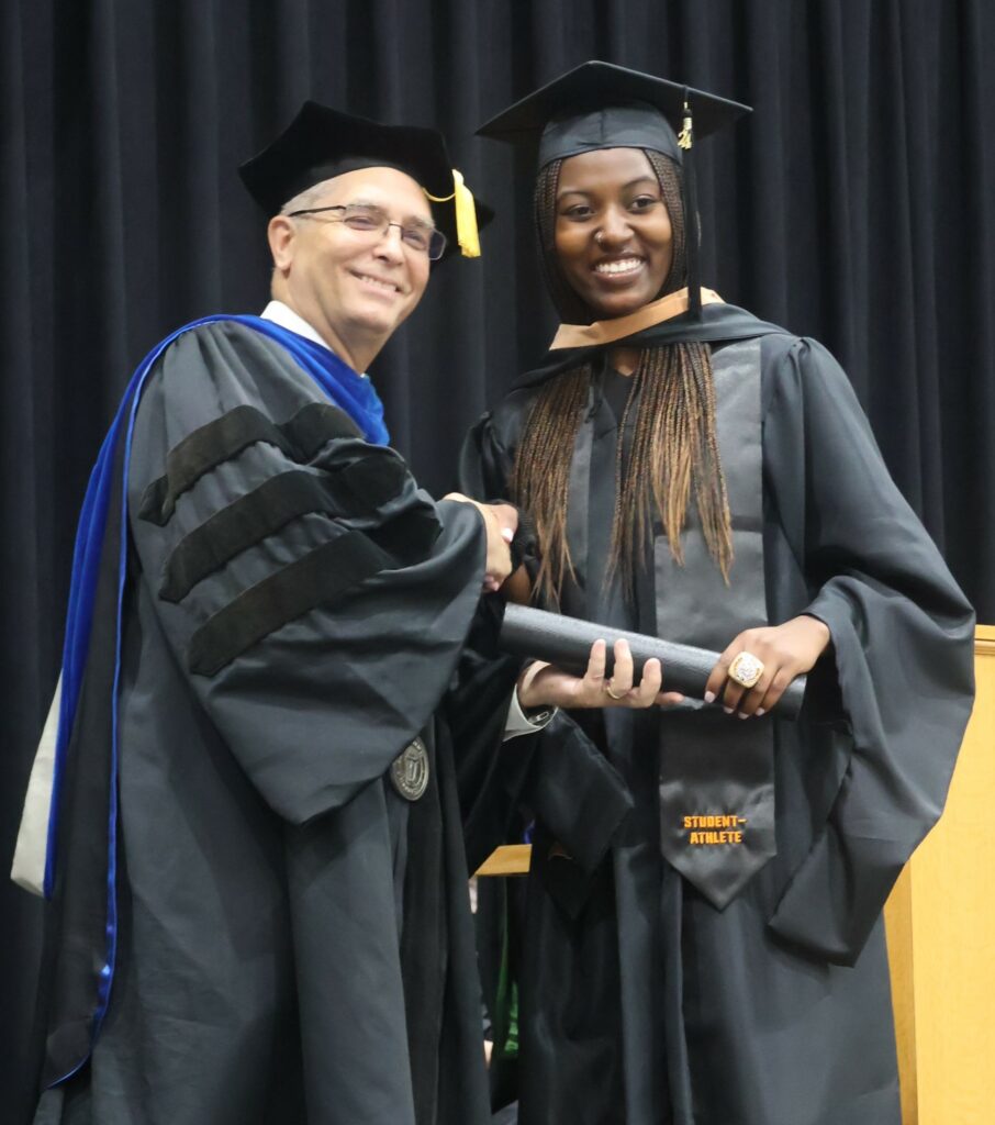 Emiah Burrowes, right, receives congratulations from Dr. Hummel.