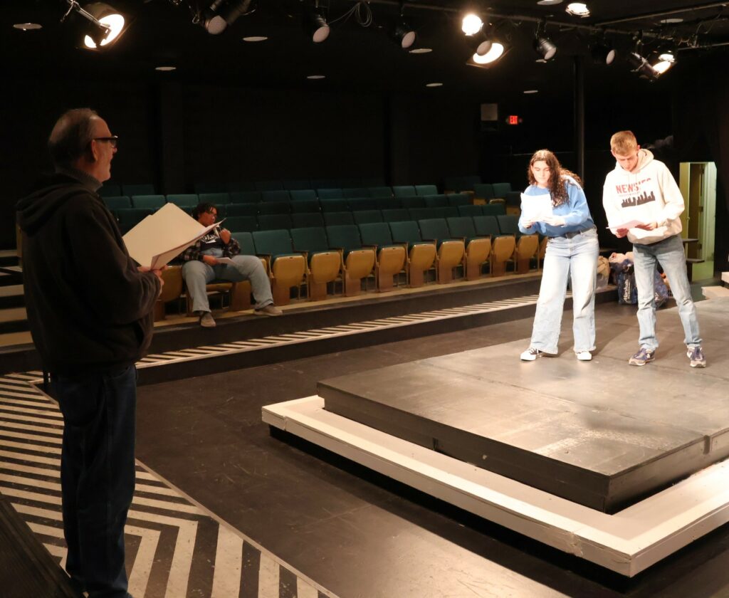 Ed Breese left, one of the directors, works with two of the actors auditioning.