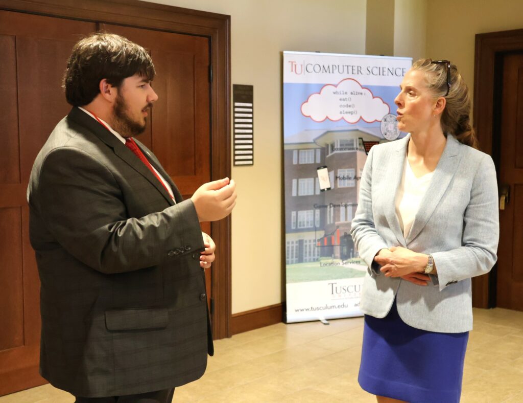 Hughston Burnheimer, left, speaks with Kelsey Trom.