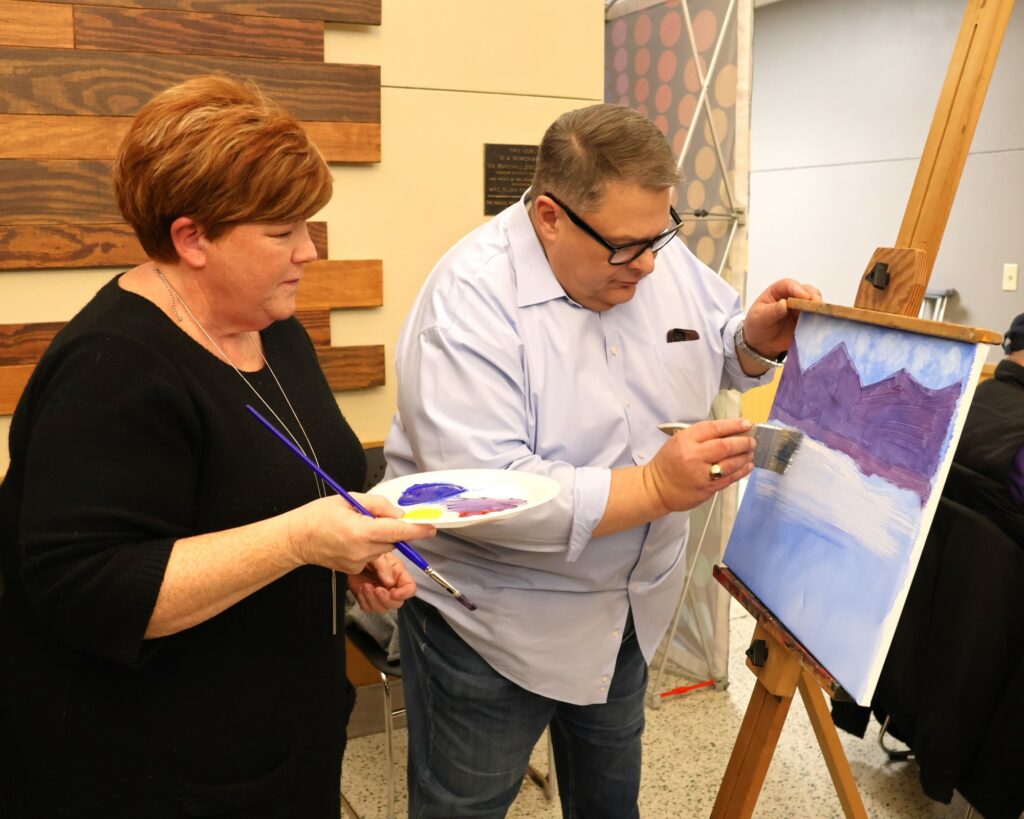 Edward Roberts, right, and his wife, Elizabeth, paint.