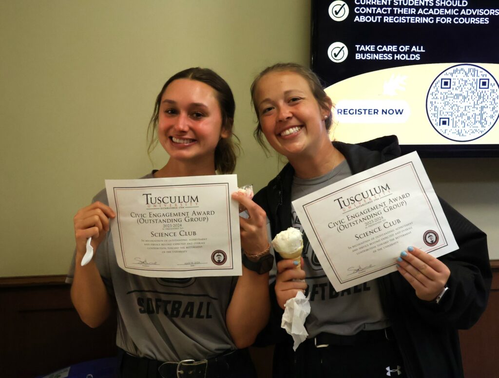 Students enjoy ice cream and show off awards received earlier in the day.