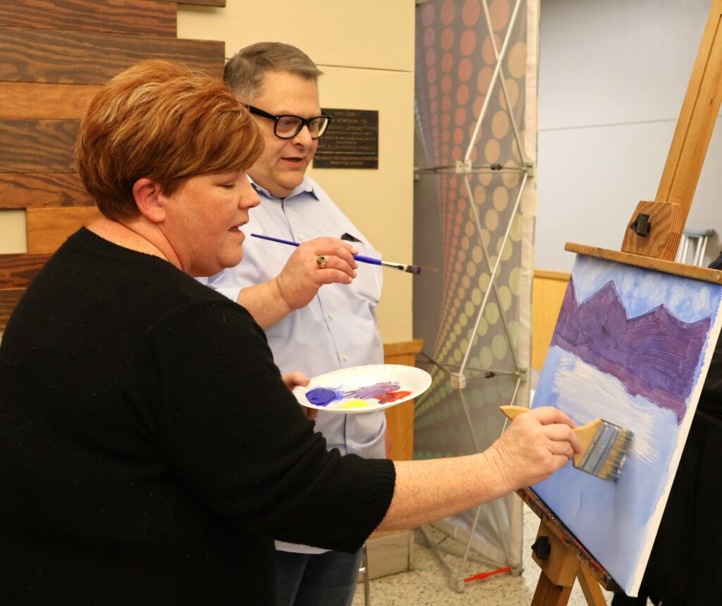Edward Roberts, right, and his wife, Elizabeth, paint.
