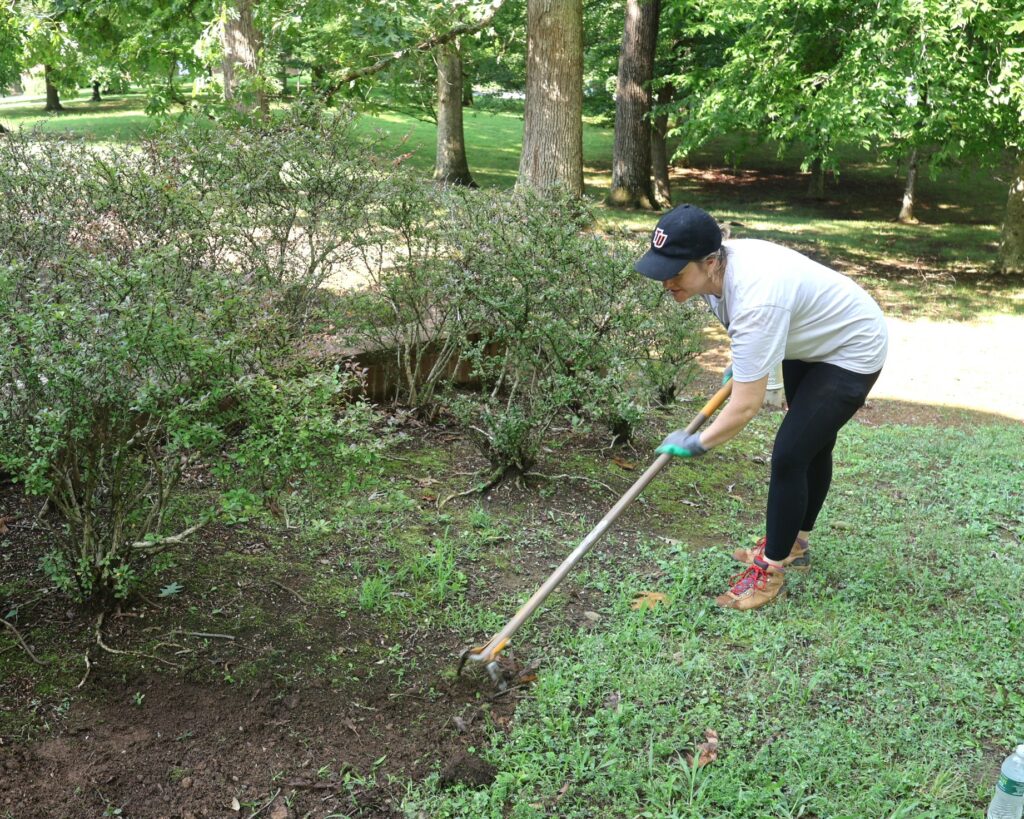 Head Spirit Coach Trea King completes some landscaping.