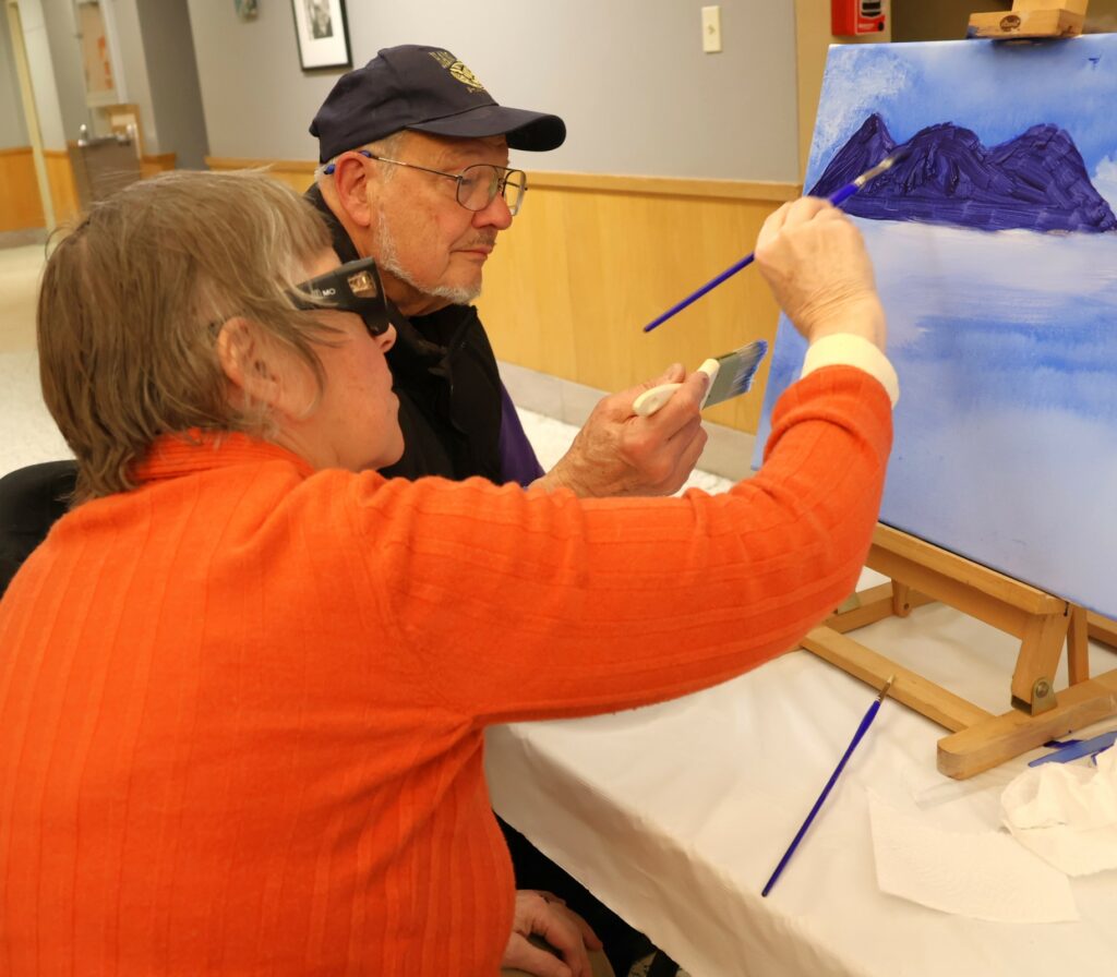 Attendees paint.