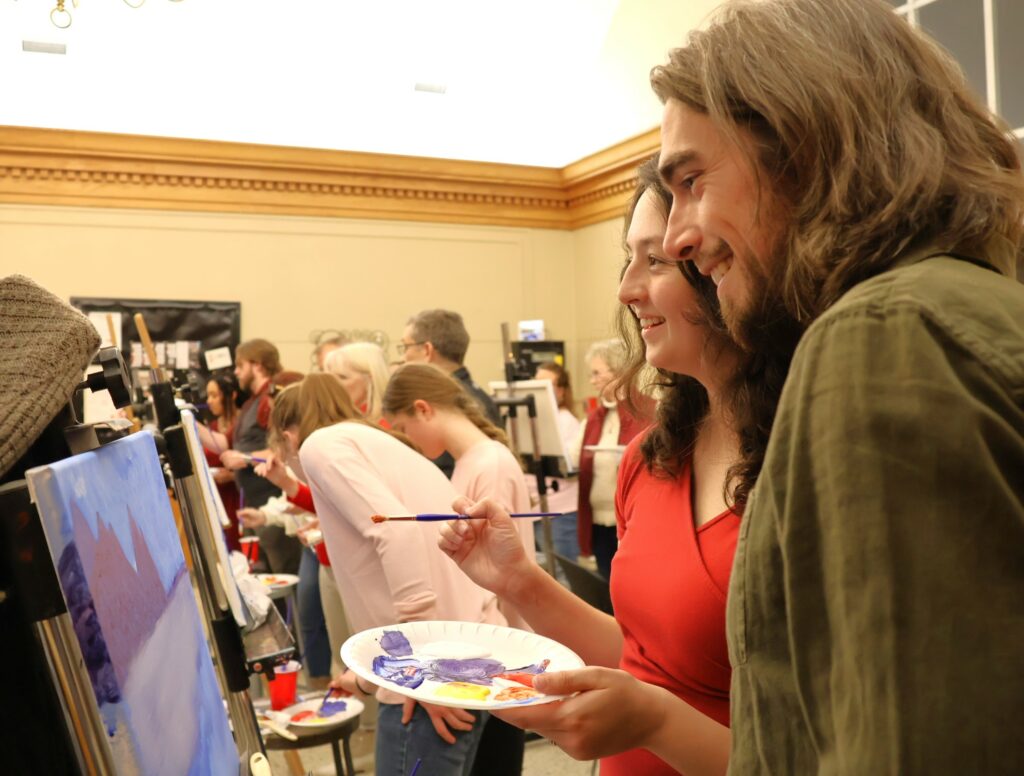 Attendees paint.