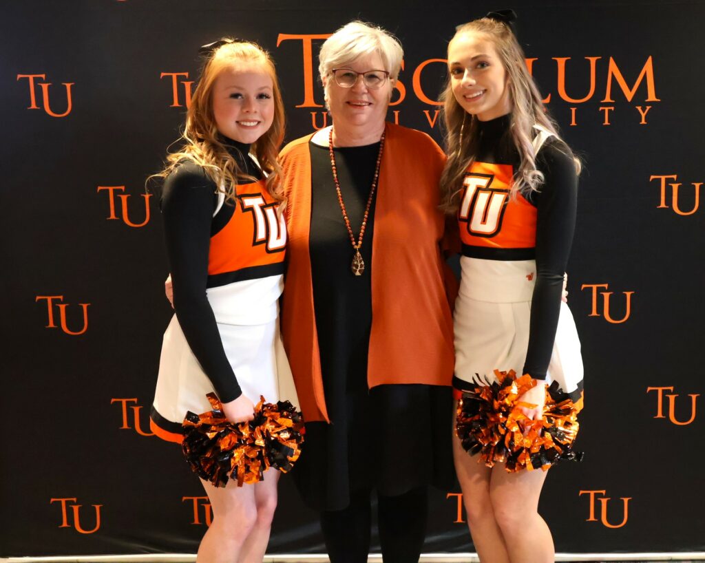 Kathy Hipps, middle, with members of the cheerleading team