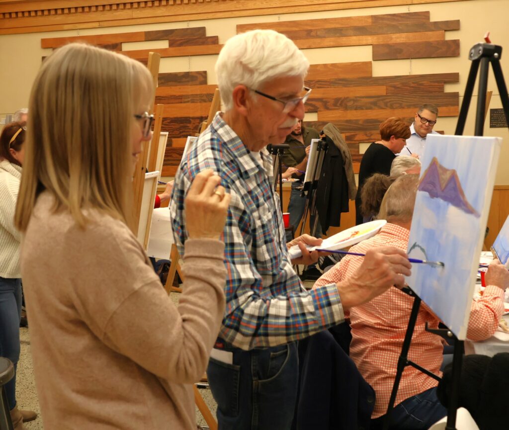 Attendees paint.