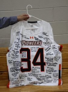 The men's lacrosse team signed Payton Cook's jersey. It will be presented to the Cook family.