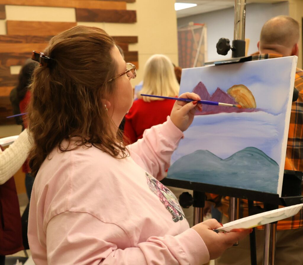 Attendees paint.