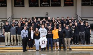 The men's lacrosse team and the Cook family gather for a photo after the service.