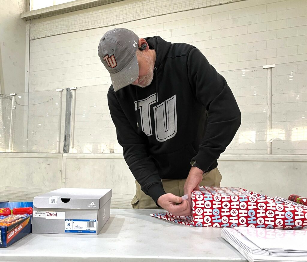 Max Olmsted wraps a gift.