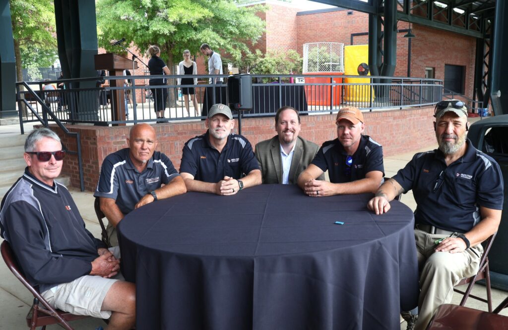 Dr. David Cook, third from right, crouches with members of the Facility Management Department.